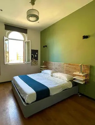 a bedroom with a large bed in a room at Stanza in appartamento adiacente metro C in Rome