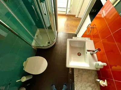 a bathroom with a sink and a mirror at Stanza in appartamento adiacente metro C in Rome