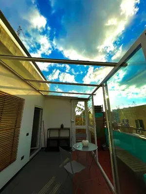 a patio roof with a table on a balcony at Stanza in appartamento adiacente metro C in Rome