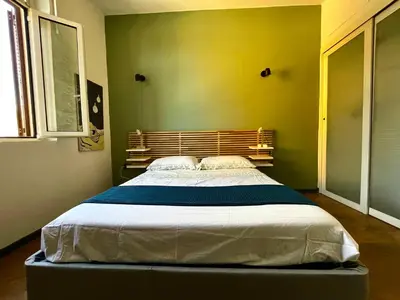 a bedroom with a large bed in a room at Stanza in appartamento adiacente metro C in Rome