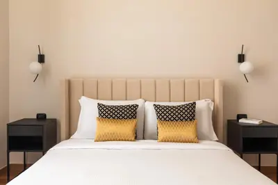 a bedroom with a white bed with two night stands at Candia Boutique Apartment in Rome