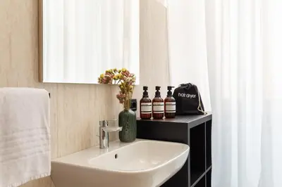 a bathroom with a sink and a mirror at Candia Boutique Apartment in Rome