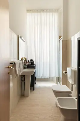 a bathroom with two sinks and two toilets at Candia Boutique Apartment in Rome