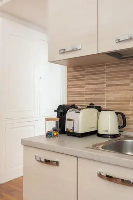 a kitchen with two toasters and a sink at Candia Boutique Apartment in Rome