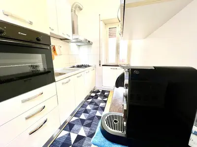 a kitchen with a black and white checkered floor at New House in Rome