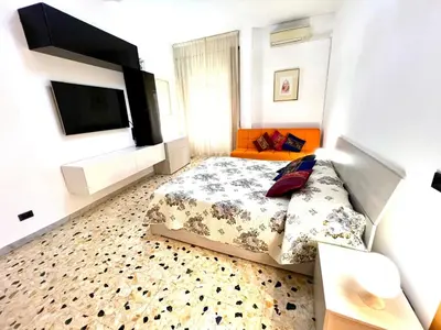 a bedroom with a bed and a flat screen tv at New House in Rome