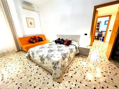 a bedroom with a bed and an orange couch at New House in Rome