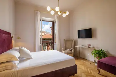 a bedroom with a bed and a tv and a window at Daplace - Lucilla Apartment in Rome