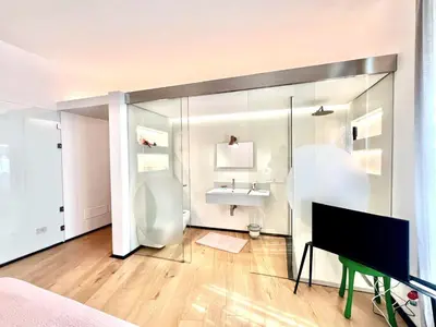 a living room with a television and a sink at The Garden in Parioli in Rome