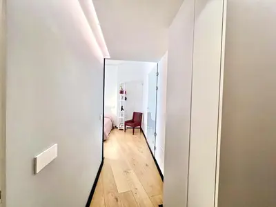 a hallway with a mirror and a chair in a room at The Garden in Parioli in Rome