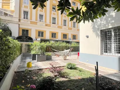 a courtyard with a hammock in front of a building at The Garden in Parioli in Rome