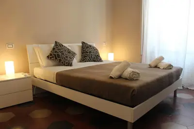 a bedroom with a bed with pillows and a window at Vaticano Roma Guesthouse in Rome