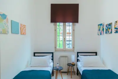 a room with two beds and a window at La casa di Nonna Peppina a Trastevere in Rome