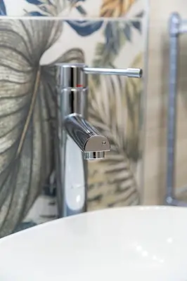 a bathroom sink with a chrome faucet at La casa di Nonna Peppina a Trastevere in Rome
