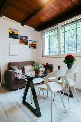 a living room with a table and chairs and a couch at La casa di Nonna Peppina a Trastevere in Rome