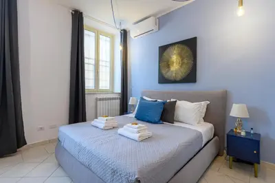 a bedroom with a bed with towels on it at HB Montebello apartment in Rome