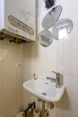 a bathroom with a sink and mirrors on the wall at HB Montebello apartment in Rome