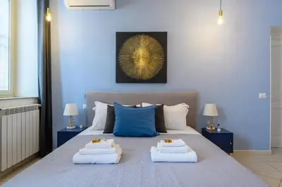 a bedroom with a bed with two towels on it at HB Montebello apartment in Rome