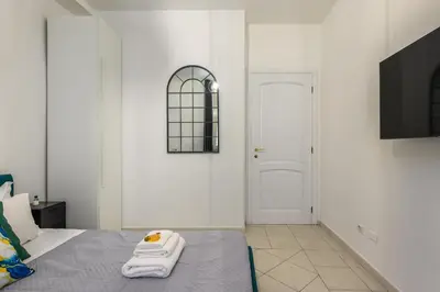 a bedroom with a bed with two towels on it at HB Montebello apartment in Rome