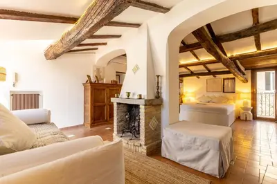 a bedroom with a green bed with a wooden ceiling at Navona Historic Lovely Terrace in Rome