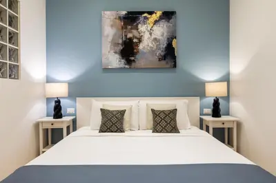 a bedroom with a large white bed with two tables at Trevi Fountain Boutique Apartment in Rome