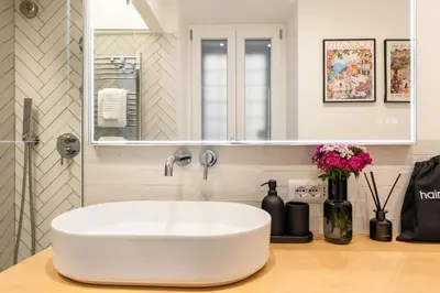 a bathroom with a white sink and a mirror at Trevi Fountain Boutique Apartment in Rome