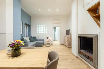 a living room with a table and a fireplace at Trevi Fountain Boutique Apartment in Rome