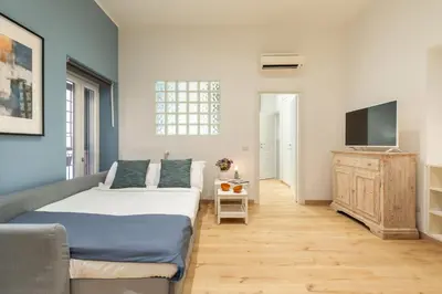 a bedroom with a bed and a flat screen tv at Trevi Fountain Boutique Apartment in Rome
