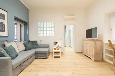 a living room with a couch and a tv at Trevi Fountain Boutique Apartment in Rome