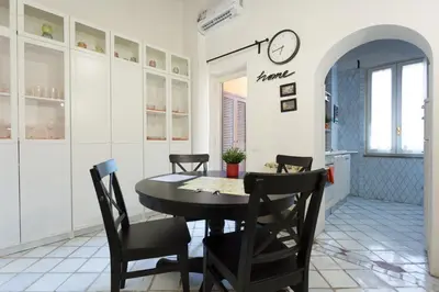 a white kitchen with a sink and a window at San Peter Borgo 68 in Rome