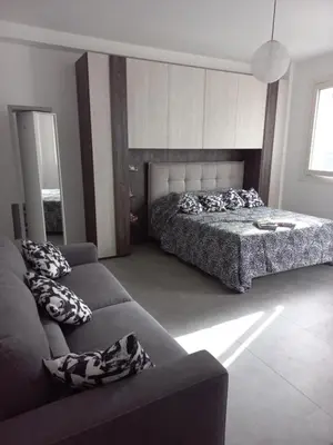 a living room with a bed and a couch at Viktoria's Suite Rome Center in Rome