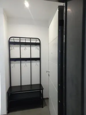 a closet with a black rack and white cabinets at Viktoria's Suite Rome Center in Rome