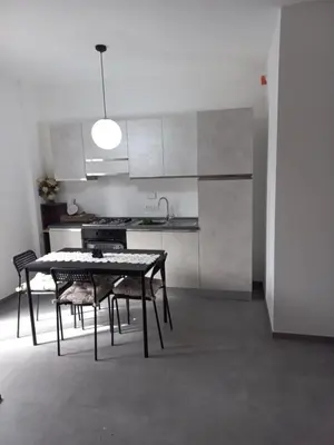 a kitchen with a table and chairs in a room at Viktoria's Suite Rome Center in Rome