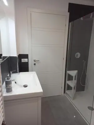a bathroom with a white sink and a shower at Viktoria's Suite Rome Center in Rome