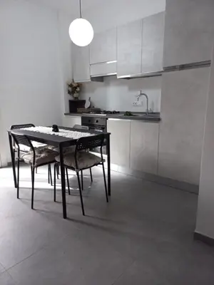 a dining room table and chairs in a kitchen at Viktoria's Suite Rome Center in Rome