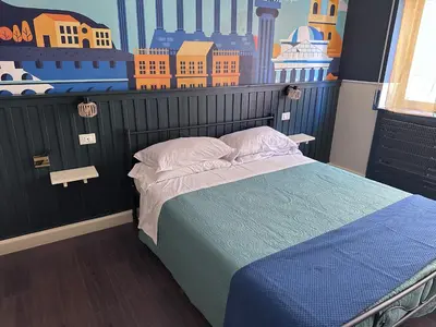 a bedroom with a bed with a map on the wall at D-Place Cozy Comfy Relaxing House in Rome in Rome