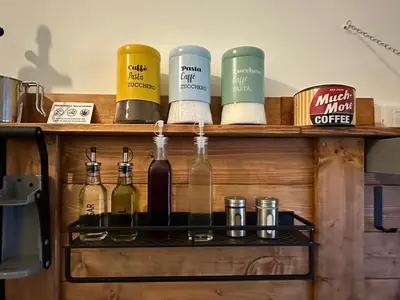 a shelf with wine bottles on it at D-Place Cozy Comfy Relaxing House in Rome in Rome