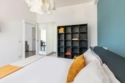 a bedroom with a bed and a shelf of shoes at Fleming 67 by Hili in Rome