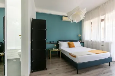 a bedroom with a bed and a blue wall at Fleming 67 by Hili in Rome