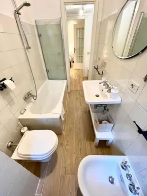 a bathroom with a toilet and a sink and a mirror at Appartamento con giardino tra San Pietro e Stadio Olimpico Roma in Rome