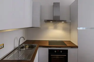 a small kitchen with a sink and a stove at City Center Apartment - Pantheon in Rome