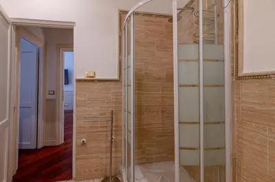 a glass shower stall in a room with a hallway at City Center Apartment - Pantheon in Rome