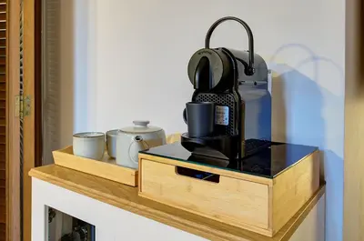 a shelf with a coffee maker and cups on it at Dimora dell'Orso in Rome