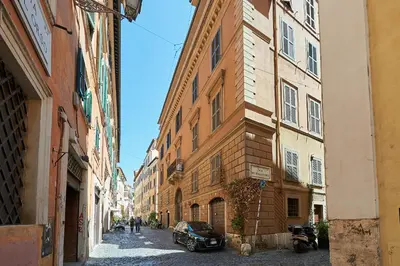 an alley with a car parked next to a building at Dimora dell'Orso in Rome