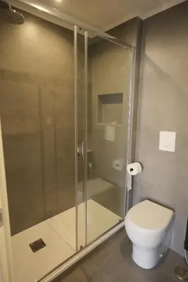 a bathroom with a toilet and a glass shower at My Maison Italy GuestHouse in Rome