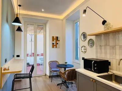 a kitchen and dining room with a table and chairs at My Maison Italy GuestHouse in Rome