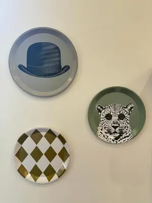 two plates and a hat on a wall at My Maison Italy GuestHouse in Rome