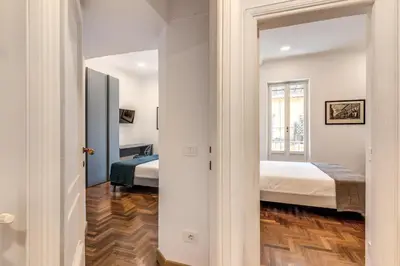 a bedroom with two beds and a mirror at Frattina Grand Suite - Vacanze Romane Apartments in Rome