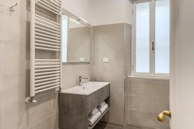 a bathroom with a sink and a mirror at Frattina Grand Suite - Vacanze Romane Apartments in Rome