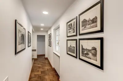 a hallway with a bunch of pictures on the wall at Frattina Grand Suite - Vacanze Romane Apartments in Rome